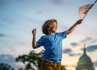 Child with American flag in Washington DC, capitol, congress building. American people celebrate...