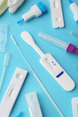 Disposable express test kits on light blue background, flat lay