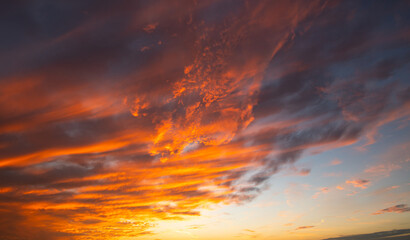 Sunrise background. Dramatic sunset background. Sky with clouds in Sunrise sky light background. Sunrise with clouds in various shapes background. Calm Sunrise.