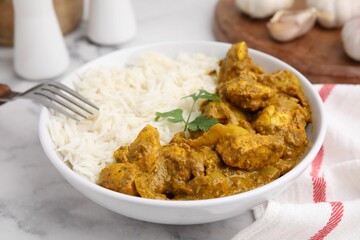 Delicious chicken curry with rice on white marble table, closeup
