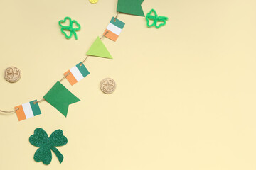 Paper garland with Irish flags and clover for St. Patrick's Day celebration on beige background