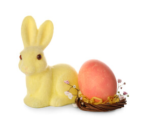 Easter red egg and yellow bunny on white background