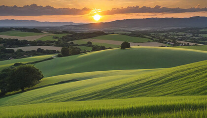 Obraz premium Sunset Landscape Featuring Hilly Countryside and Farmland