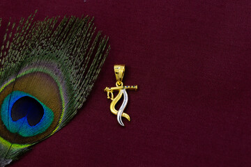 feather with krishna pendant