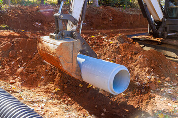 Installation of pipework at construction site to facilitate flow of rainwater into water main...