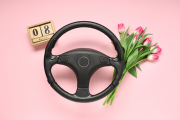 Steering wheel, tulip flowers and cube calendar with date of International Women's Day on pink background - obrazy, fototapety, plakaty
