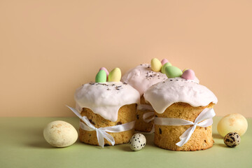 Composition with delicious Easter cakes and painted eggs on color background