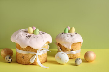 Composition with delicious Easter cakes and painted eggs on color background