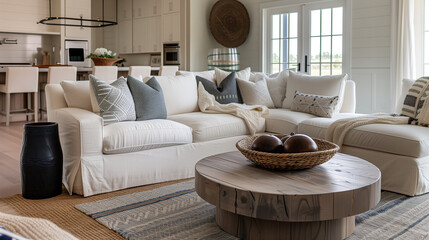Modern farmhouse living room with sectional sofa, rustic round table, and layered rugs