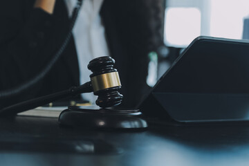 Judge gavel with Justice lawyers having team meeting at law firm background. Concepts of Law and Legal services.