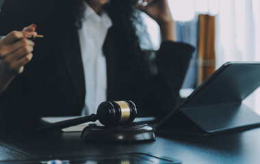 Judge gavel with Justice lawyers having team meeting at law firm background. Concepts of Law and Legal services.