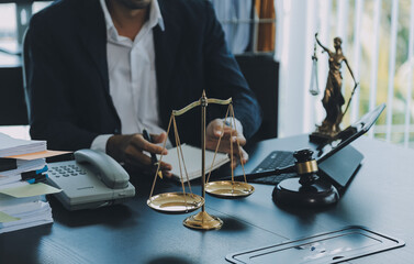 Judge gavel with Justice lawyers having team meeting at law firm background. Concepts of Law and Legal services.