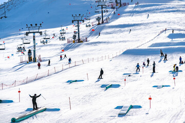 Ski hill with chairlifts and snow making machines for skiers and snowboarders