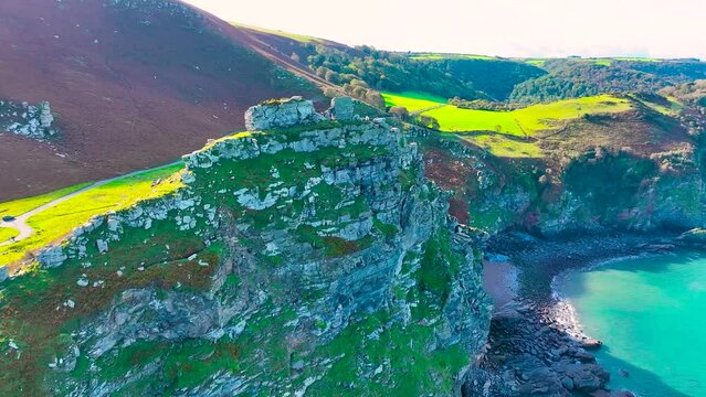 Photographer shooting the Valley of Rocks,  a dry valley that runs parallel to the coast in north Devon in Exmoor national park in England, UK