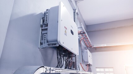 Close up the  inverter unit for solar panel on the wall. Technology of solar energy with shiny light. © Suranto
