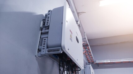 Close up the  inverter unit for solar panel on the wall. Technology of solar energy with shiny...