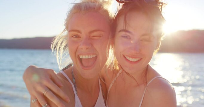 Kiss, women and friends on vacation with laugh, blowing kisses and happy at beach in Spain. Friendship, travel and memories with adventure for bonding, enjoy and relax on trip for summer holiday