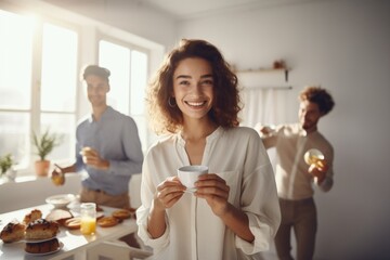 Smiling woman enjoying coffee during a sunny breakfast gathering