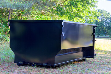 Located on construction site is metal container dumpster that is used to dispose of repair junk...
