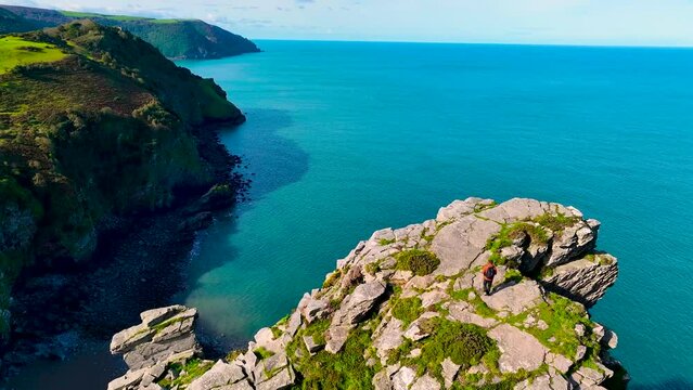 Photographer shooting the Valley of Rocks,  a dry valley that runs parallel to the coast in north Devon in Exmoor national park in England, UK