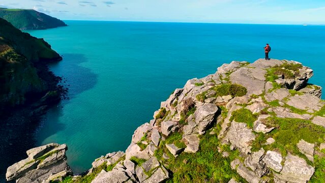 Photographer shooting the Valley of Rocks,  a dry valley that runs parallel to the coast in north Devon in Exmoor national park in England, UK