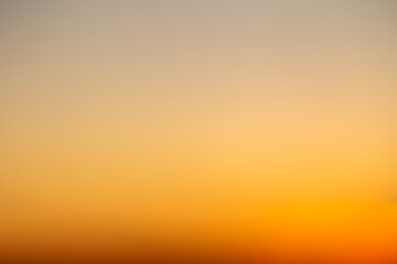 Abstract defocused shot of the sky during sunset hours casting a deep orange light - Powered by Adobe