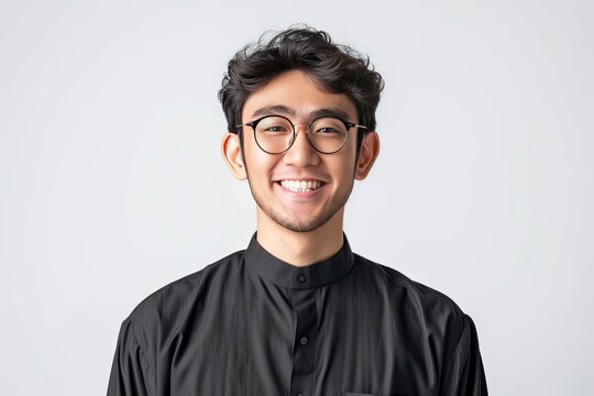 Asian Muslim man wearing glasses smiling to give greeting during Ramadan and Eid Al Fitr celebration over white background, realistic, HD, copy space - generative ai