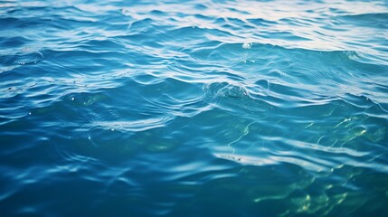 Fototapeta premium Blue green surface of the ocean in Catalina Island California with gentle ripples on the surface and light refracting