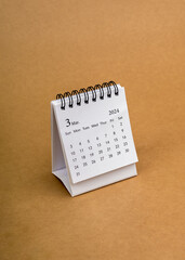 A March 2024 desk calendar for the organizer to plan and reminder isolated on brown craft paper...