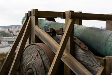 Old cannons in the Lisbon bastion. Castelo de S. Jorge cannons and view on the city. Ancient...