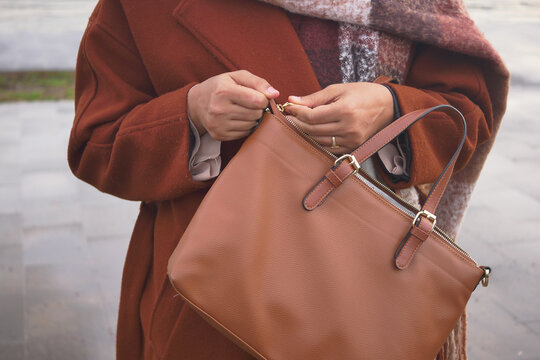 women Unzipping her purse close up 