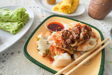 A beef rice noodle roll with chili oil, also known as a steamed rice roll and cheung fun. Ci Cong Fan. Eating steamed chinese dumpling dim sum. Authentic typical chinese food.