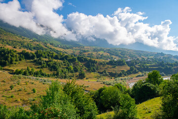 Obraz premium Verdant Dreamscape: Green Mountains Floating in the Expanse of Blue