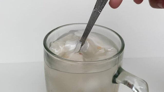 Beverage made from chilled or iced coconut water and young coconut flesh, isolated on white background