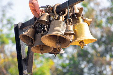 Ringing bells of a religious temple. Brass praying bells hanging on old temple