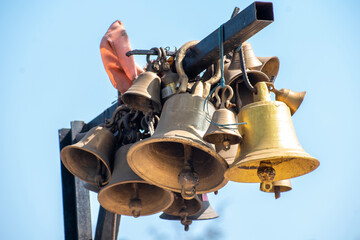 Ringing bells of a religious temple. Brass praying bells hanging on old temple