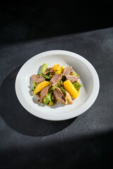 Duck salad with orange slices, walnuts, and a balsamic glaze, a perfect fusion of flavors