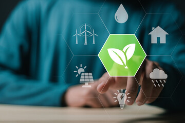 Sustainable energy concept. Person touching virtual Environment icon for sustainable energy at home. Environmental green energy. - obrazy, fototapety, plakaty