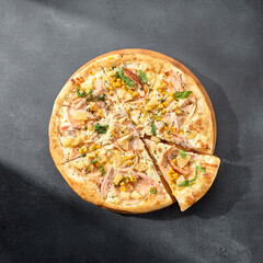 Hawaiian pizza with chicken, pineapple, and corn, a sweet and savory combination on a perfectly baked crust