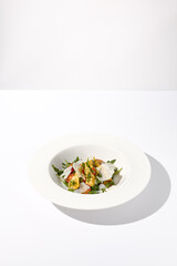 Artichoke and tomato salad with shaved Parmesan cheese