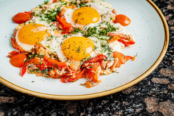 fried eggs with tomatoes and herbs