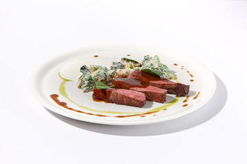 Beef steak with creamed spinach and mushrooms on elegant white dish, ideal for fine dining and gourmet cuisine