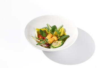 Vegetable salad bowl with avocado and cheese tempura balls on an isolated white background