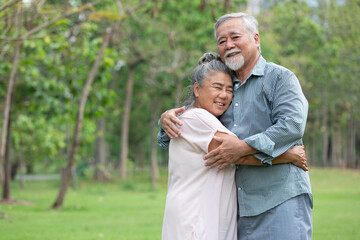 senior couple in love, embracing and hugging each other in the park