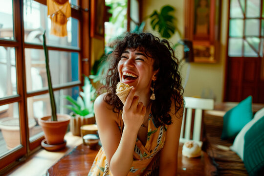 Curly hispanic woman eating vegan ice-cream in eclectic interior design appartment, summer vibes