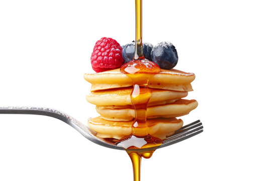 A fork with a stack of mini pancakes drizzled with syrup and topped with berries creates a delicious breakfast close-up.