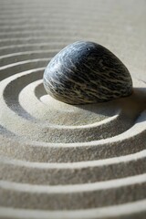 Fototapeta na wymiar a rock sitting on top of a sandy area