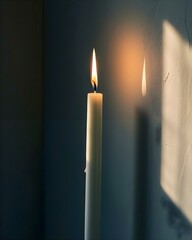a candle is lit next to a wall
