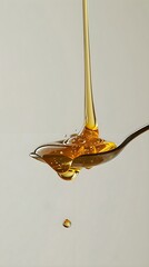 a spoon with liquid pouring out of it