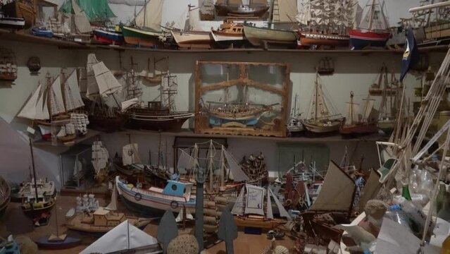Symi island, Greece - 9th of October 2023: Viewing collection of toy boats gathered in the Monastery of Archangel Michael of Panormitis

